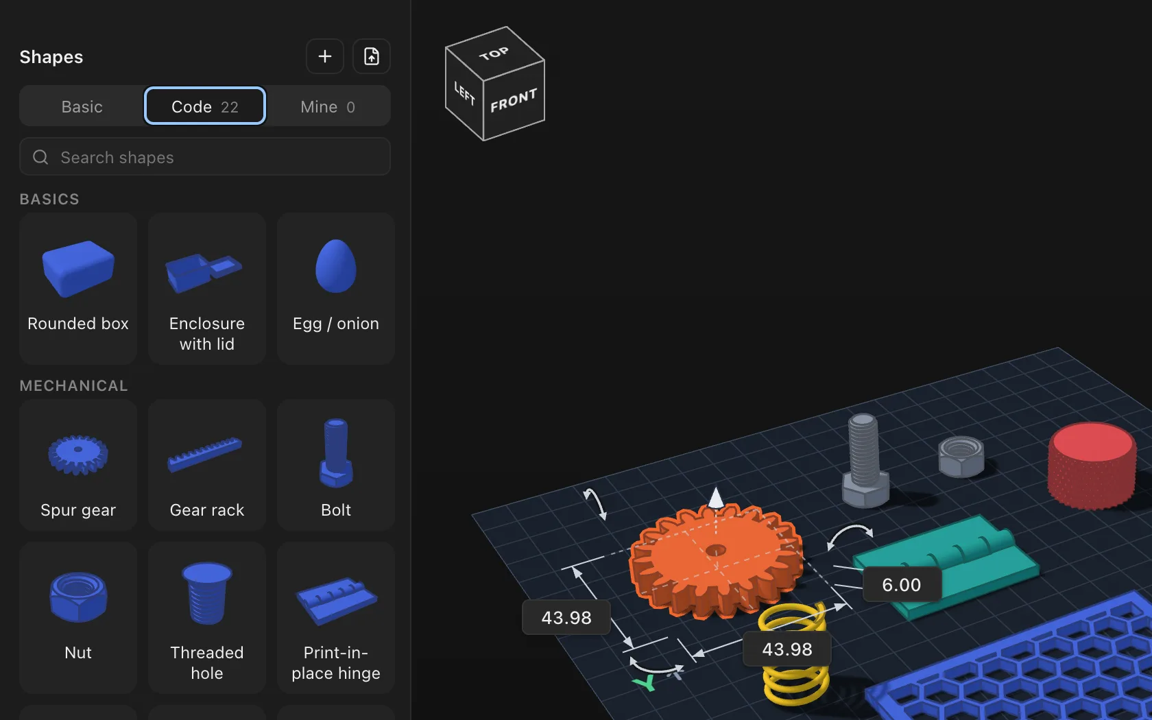 The Code tab of the Shapes panel: rounded box, enclosure with lid, egg, spur gear, gear rack, bolt, nut, threaded hole and hinge, beside a gear on the workplane.