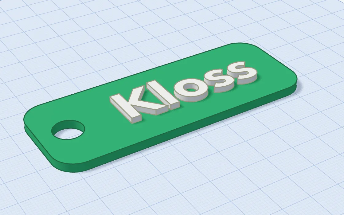 A green key tag with a ring hole and raised white letters reading Kloss.